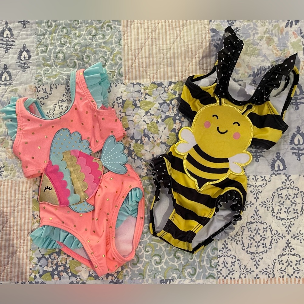 2 gently used Wetsuit brand Swimsuits size newborn. Adorable fish and bumble bee